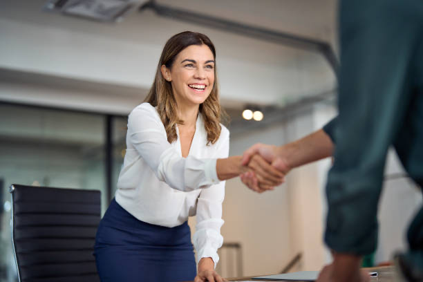 Two professionals shaking hands in an office