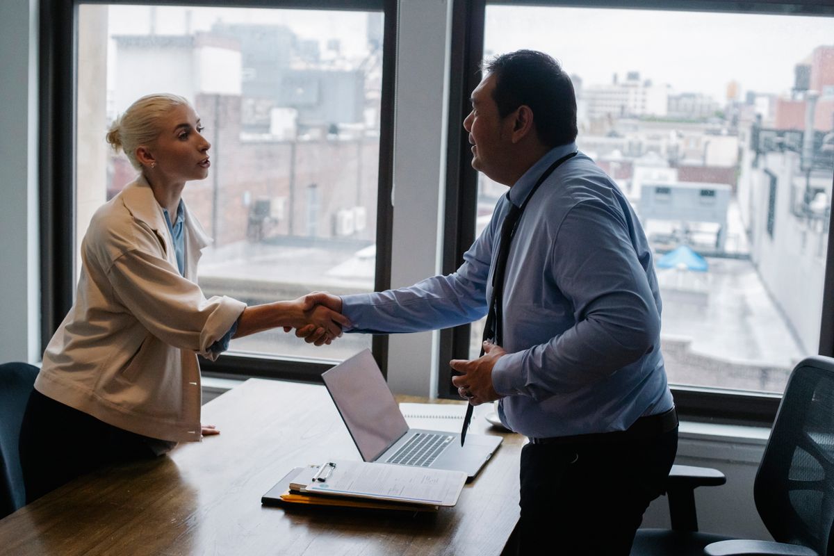 A mentor and mentee shaking hands at their first meeting